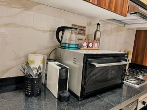 a kitchen with a toaster oven on a counter at Cozy Appart central à terrasse in Casablanca