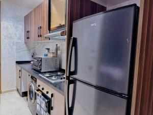 a kitchen with a stainless steel refrigerator at Cozy Appart central à terrasse in Casablanca