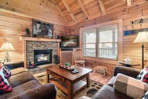 a living room with a couch and a fireplace at Bearadise Hot Tub 6 Min to The Island in Pigeon Forge