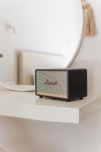 a small radio sitting on a counter next to a mirror at Scarabeo Hotel & Villas Parga in Parga