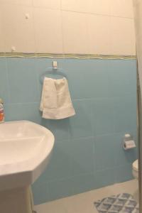 a blue bathroom with a sink and a towel at amplia y cómoda casa 