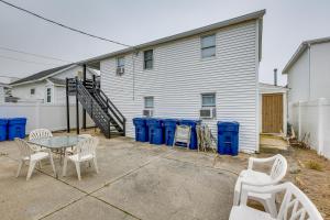 a patio with a table and chairs in front of a building at Wildwood Apartment, Walk to Crest Pier and Beach! in Wildwood