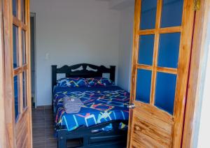 a bedroom with a bed and a wooden door at Cabañas en San Antero Bambumar2 in San Antero