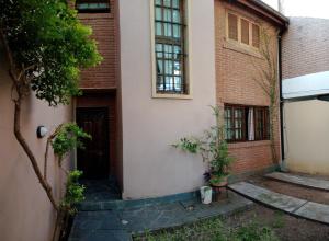 a brick house with a door and a window at Casa con excelente ubicacion in Posadas +16 photos
