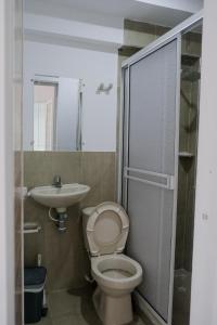 a bathroom with a toilet and a sink at Cabañas en San Antero Bambumar2 in San Antero