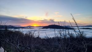 Cortijo Jiménez - Casa Rural في Pitres: غروب الشمس على بحر من الغيوم في الجبال