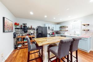 a kitchen with a wooden table and chairs at Three Bears Cabin in Blowing Rock +10 photos