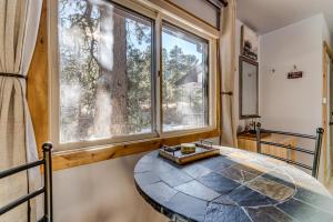 a room with a round table in front of a window at Mountain Love Views in Estes Park
