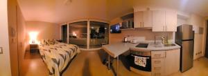 a kitchen with a bed and a table in a room at dpto x día chillan 1411 in Chillán