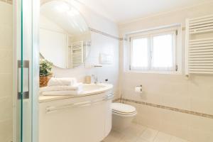 a bathroom with a sink and a toilet and a mirror at Dream Suite in Como in Como +29 photos