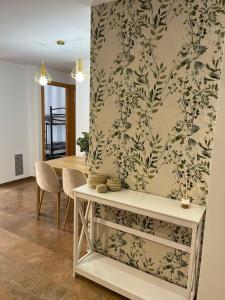 a dining room with a table and a wall at Apartamentos Jardín Turquesa in Lloret de Mar