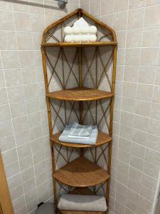 a shelf in a bathroom with towels on it at Apartamentos Jardín Turquesa in Lloret de Mar