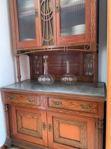 a wooden cabinet with two vases on top of it at casa gerente in Muros