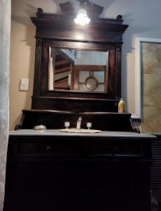 a bathroom with a sink and a mirror at Tres Coronas in San Martín de los Andes +61 photos