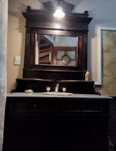 a bathroom with a sink and a mirror at Tres Coronas in San Martín de los Andes