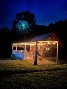 a cabin with lights on the side of it at night at Glamping Villa del Bosque in Santa Rosa de Cabal