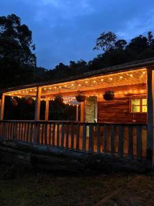 a house with christmas lights on the side of it at Glamping Villa del Bosque in Santa Rosa de Cabal