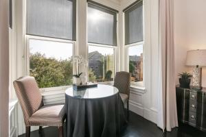 a room with windows with a table and chairs at Pacific Heights Chic Jr Studio in San Francisco