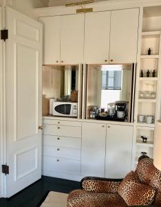 a kitchen with white cabinets and a microwave at Pacific Heights Chic Jr Studio in San Francisco