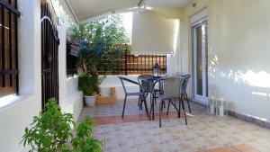 a balcony with a table and chairs on a patio at Neapolis Apartment in Lefkada +14 photos