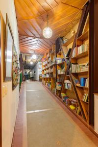 eine Bibliothek mit Holzregalen mit Büchern in der Unterkunft Hotel Veraneras del Quindío in Pueblo Tapao