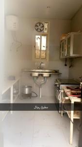 a kitchen with a sink and a counter top at منتجع السرايا السياحي in Al Qā‘id