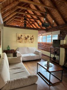 a living room with a couch and a table at Cabañas Temistocles in Esquel