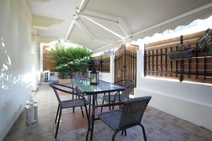 a patio with a table and chairs on a patio at Neapolis Apartment in Lefkada