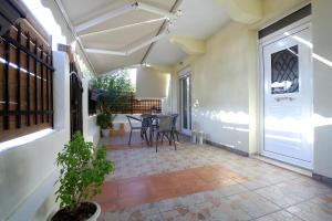 an outdoor patio with a table and chairs at Neapolis Apartment in Lefkada