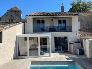 an extension to a house with a swimming pool at La villageoise in Montagne