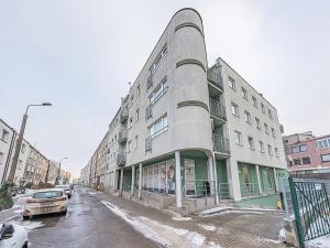 a tall building on a city street in the snow at CITYSTAY Reja Apartament z parkingiem in Gdynia