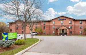 a red brick building with a sign in front of it at Extended Stay America Select Suites - South Bend - Mishawaka - South in South Bend
