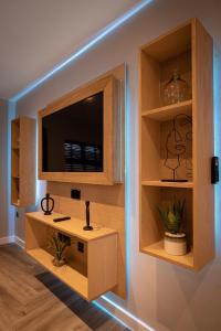 a room with a tv in a wall with shelves at The Charleston in Blackpool