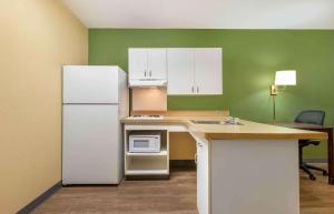 a kitchen with a white refrigerator and a counter at Extended Stay America Suites - Fairfield - Napa Valley in Fairfield