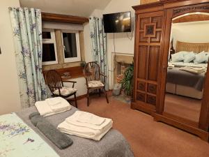 a bedroom with a bed and a mirror and a bed at Coxleigh House in Chesterfield