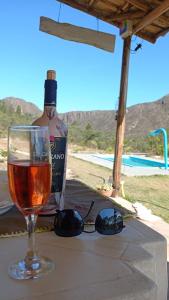 a glass of wine sitting next to a bottle of alcohol at Chalé Bella Vista Privacidade e Exclusividade in Ouro Preto