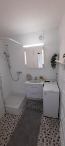 a bathroom with a sink and a tub and a toilet at Apartment Horizont in Bad Sachsa
