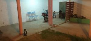 a motorcycle parked in a garage next to a wall at Wasi in La Falda