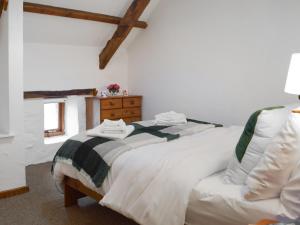 a bedroom with two white beds and a window at Ty Ceffylau - Uk46190 in Llanybydder