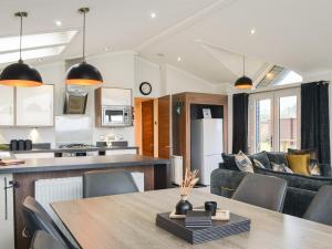 a kitchen and living room with a table and chairs at Lake View No, 65 in Routh