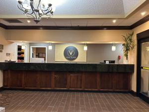a lobby with a reception counter in a hotel at Vista Suites Near Island and Leconte Convention Center in Pigeon Forge