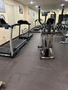a gym with several tread machines in a room at Vista Suites Near Island and Leconte Convention Center in Pigeon Forge