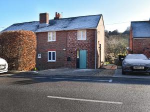 a brick house with a car parked in front of it at The Apricot Tree in Carisbrooke