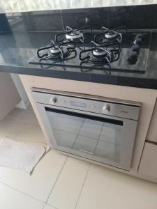 a stove top oven sitting in a kitchen at Apartamento Praia do Futuro mobiliado in Fortaleza