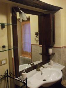 a bathroom with a sink and a mirror at La Casetta Vacanze in Molini di Triora