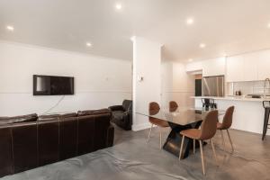 a living room with a couch and a table and chairs at 3 Bedrooms apartment-1897 in Montréal