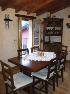 a dining room with a wooden table and chairs at La Casetta Vacanze in Molini di Triora +8 photos