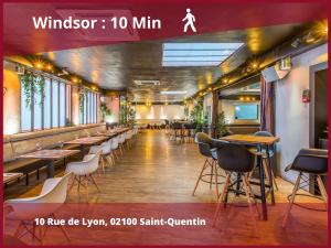 un restaurante con mesas y sillas en una habitación en 03 LOVE ROOM By Fanny S, en Saint-Quentin