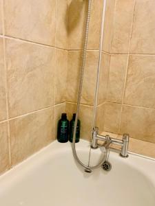 two bottles sitting on top of a bath tub at Finsbury Park London Apartment - 10 minutes to central London in London
