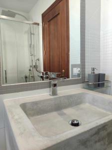 baño con lavabo grande con espejo en Casa Mirador del Puente, en Arcos de la Frontera